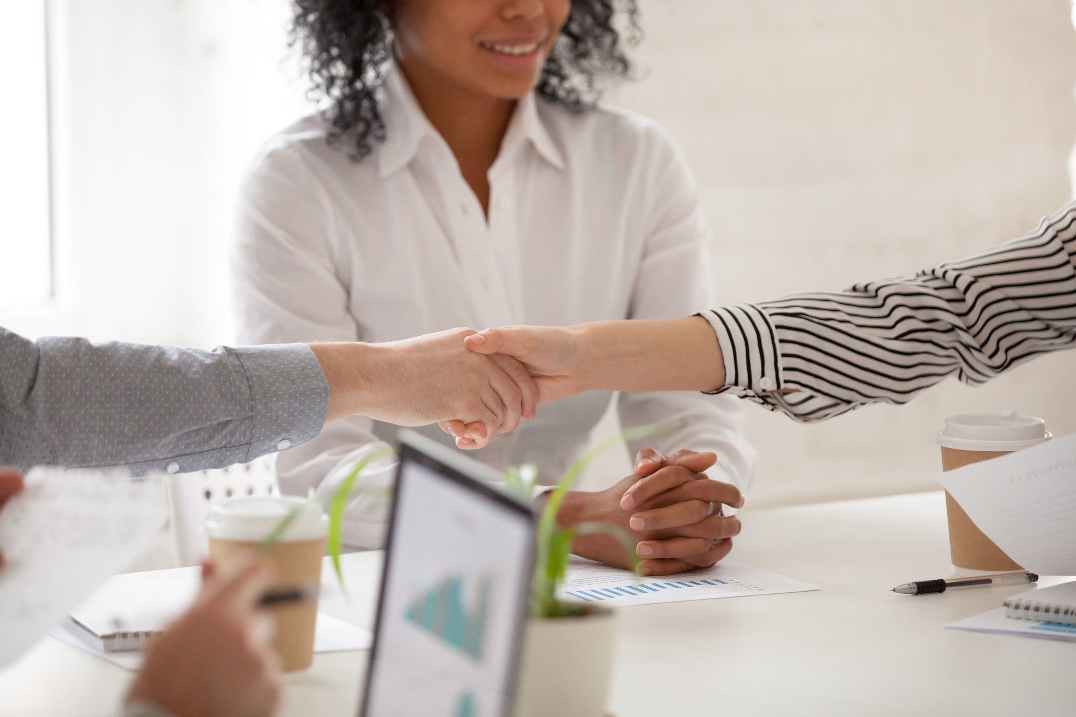 Two people shaking hands at a mediation